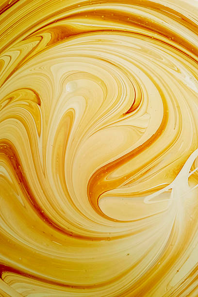 Marble texture. yellow painted waves. Modern artistic design. Vertical photograph.