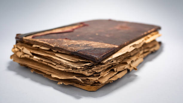 istock Ancient book with worn pages and faded cover resting on a neutral surface 2206338049