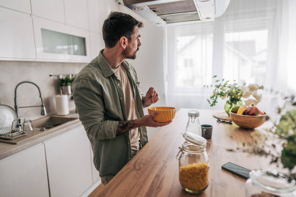 istock Man enjoying a healthy breakfast in modern kitchen 2206338869