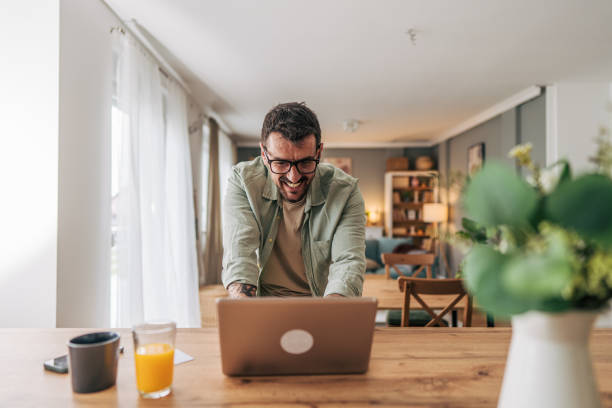 istock Happy freelancer working from home on laptop and smiling 2206339140