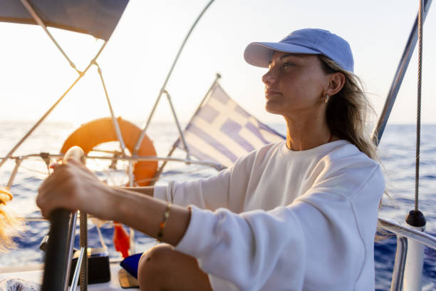 istock Woman skipper on a sailboat 2206341358