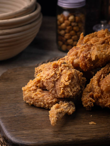 istock Crispy Fried chicken on a wooden plate Set on dark dinning table. 2206341731