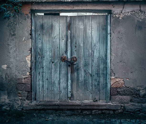 istock Weathered Wooden Doors with Chain Lock and Stone Surround 2206345547