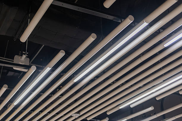 istock Suspended tube ceiling decoration with integrated linear lighting for diffused illumination, ideal for public space 2206347333