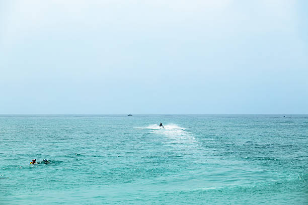 man rides a jet ski on turquoise waters in the lagoon