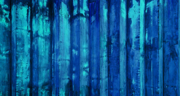 close up weathered blue corrugated metallic wall, displaying a mesmerizing interplay of light and shadow that creates a pattern of vertical lines. close up weathered blue corrugated metallic wall, displaying a mesmerizing interplay of light and shadow that creates a pattern of vertical lines. old blue rusty metal sheet wall use as background. corrugated metal fence ideas stock pictures, royalty-free photos & images
