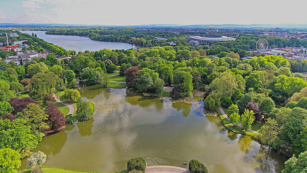 Hanover, Germany - May 03, 2011: Aerial View of Calm Water Masch Park Lake Green Nature Oasis in City at Spring Day.