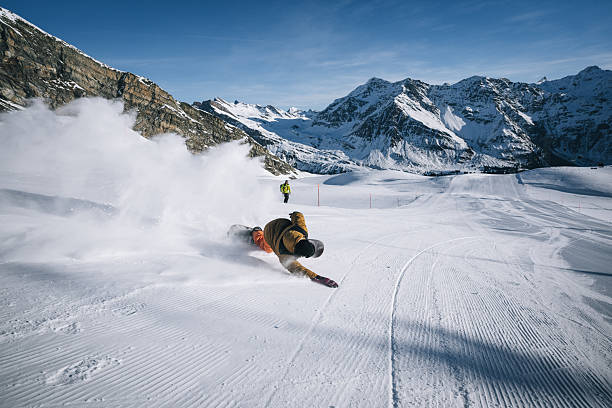 istock Snowboarder descends mountain at ski resort 2206351448