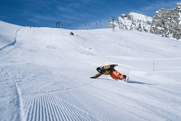 istock Snowboarder descends mountain at ski resort 2206351772