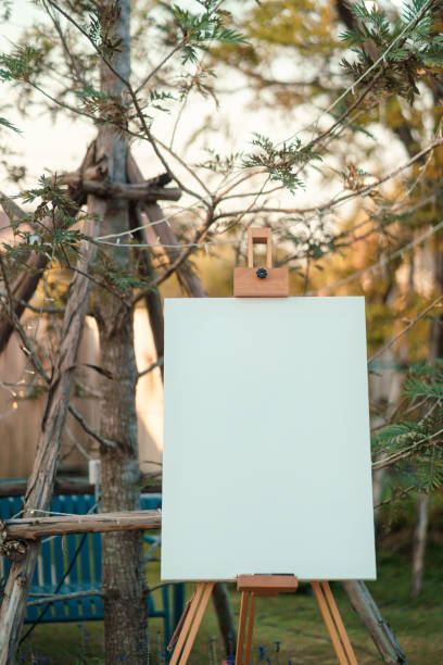 istock Blank canvas set on wooden easel placed front of wedding event in rustic style 2206352050