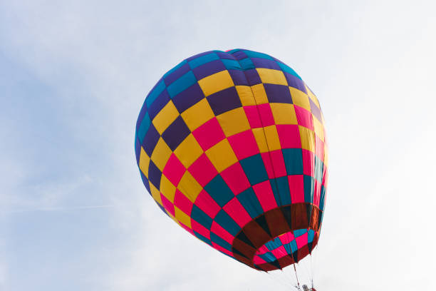 istock Colorful hot air balloon floating in blue sky 2206352065