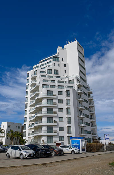 istock Modern architectural marvel rises against a vibrant blue sky in a bustling urban landscape filled with vehicles and energy 2206352666