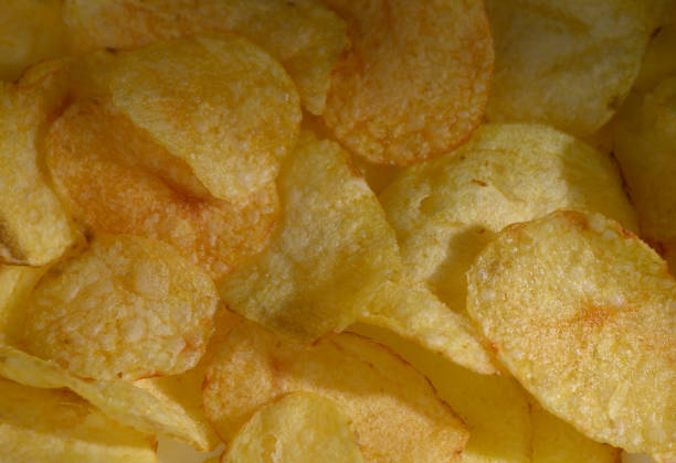 istock Crispy golden potato chips piled high, creating a tempting snack experience perfect for any occasion 2206352670