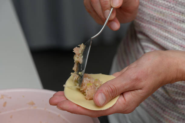 istock Creating delicious dumplings with skilled hands in a cozy kitchen during an afternoon gathering 2206352671