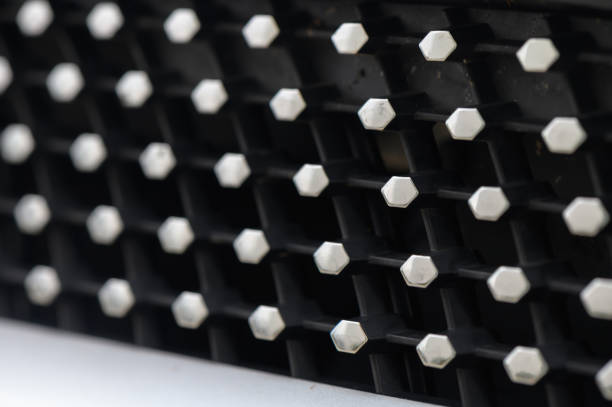 A detailed exploration of a textured black surface adorned with numerous raised hexagonal shapes.