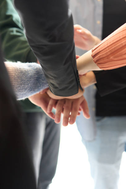 istock A top view of business people joining hands in a circle, symbolizing unity, collaboration, and shared success in the workplace 2206355011