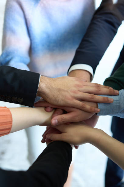 istock A top view of business people joining hands in a circle, symbolizing unity, collaboration, and shared success in the workplace 2206356152
