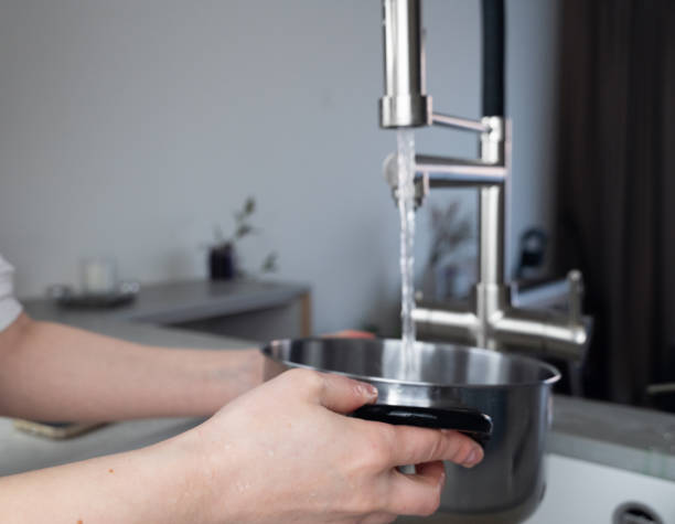 istock Filling a Pot with Fresh Water from a Modern Kitchen Faucet for Everyday Cooking Tasks 2206356295