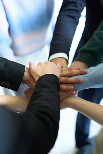 istock A top view of business people joining hands in a circle, symbolizing unity, collaboration, and shared success in the workplace 2206356372