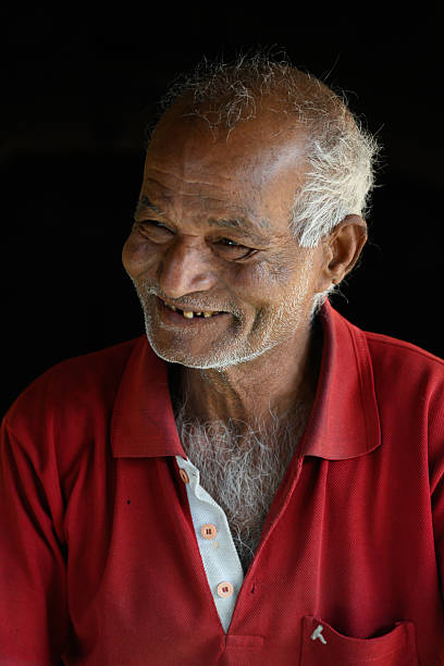 A close-up portrait of a mature man with a warm, genuine smile against an off-white background. The image captures a sense of confidence, experience, and positivity, making it ideal for use in professional, lifestyle, or wellness-related content. The neutral background allows for versatile application in various designs and marketing materials.