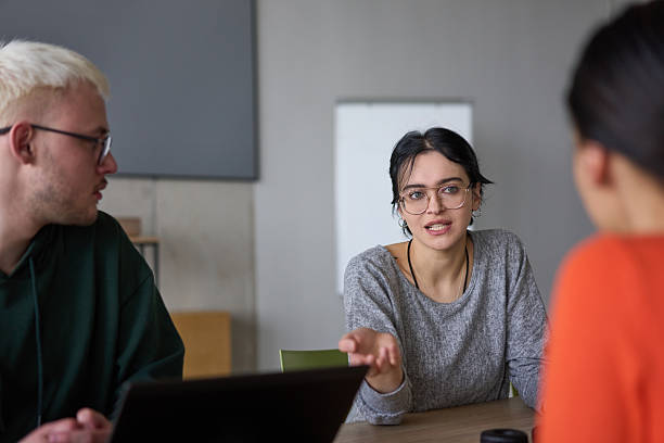 istock A young, diverse business team sitting together in a modern office, exchanging ideas and business plans, fostering collaboration and innovation for future success. 2206358025