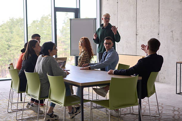 istock A young, diverse business team sitting together in a modern office, exchanging ideas and business plans, fostering collaboration and innovation for future success. 2206358618