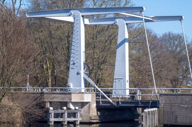 istock White metal drawbridge over canal connecting to river under blue sky 2206359197
