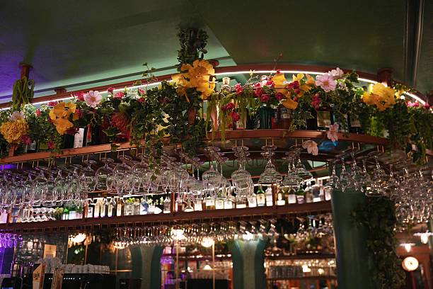 Decorative bar shelf with hanging glasses and flowers