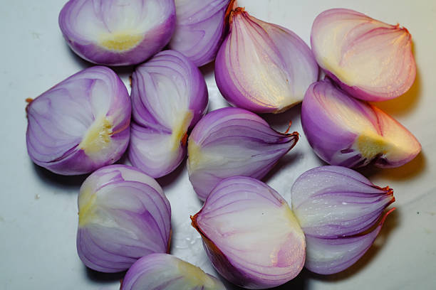 Studio shot of shallot bulbus layer. A photostock of purple shallot cut open showing bulbus layer, High Quality. Closeup of shallot skin layer. Aromatic Spices. Grapich Resources. Macrophotography