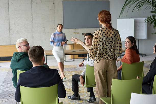 istock A diverse group of business professionals sits attentively in a modern office, actively participating in a training session led by an instructor, focusing on the latest technological advancements in the business world. 2206360734