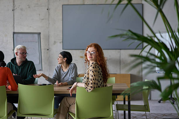 istock A young, diverse business team sitting together in a modern office, exchanging ideas and business plans, fostering collaboration and innovation for future success. 2206361373