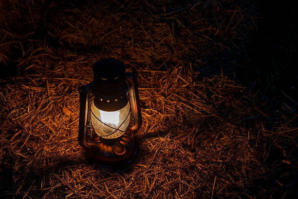 istock antique kerosene lamp with lights on a haystack in a barn at night 2206362620