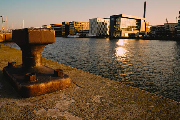 istock Rising sun on a spring morning in Bremerhaven. Rusty bollards for mooring ships. 2206363932