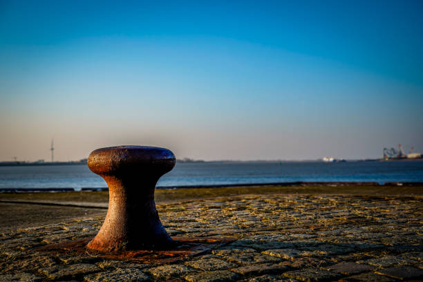 Rising sun on a spring morning in Bremerhaven. Rusty bollards for mooring ships.