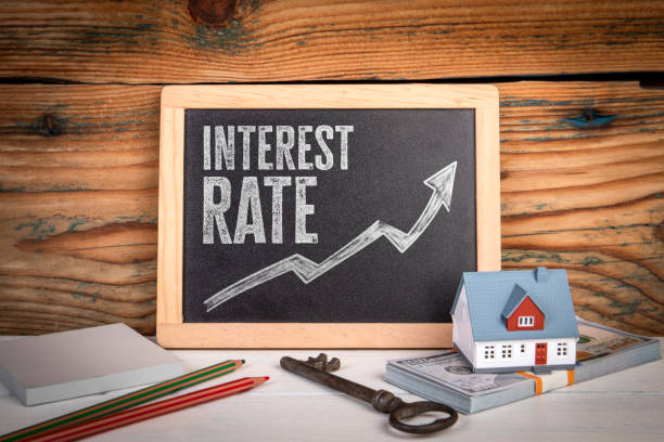istock Interest Rate Concept with Arrow, Money, House Model, and Chalkboard 2206364334