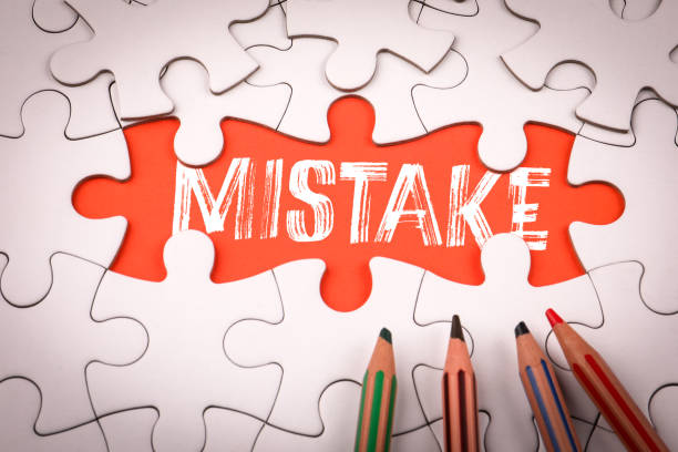 istock MISTAKE. White puzzle pieces and colored pencils 2206364336