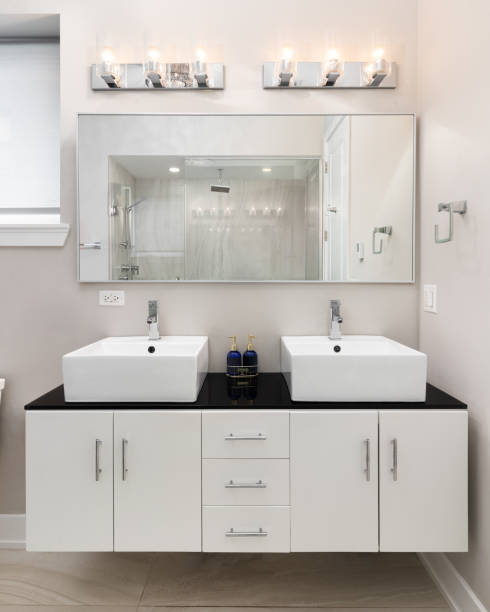 istock A bathroom with a floating cabinet and vessel sinks on a black countertop. 2206365260