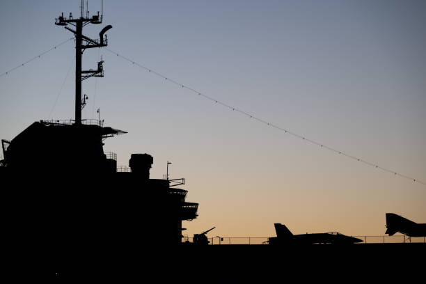 istock Aircraft carrier silhouette against twilight sky with fighter jets at naval base during evening hours 2206366366