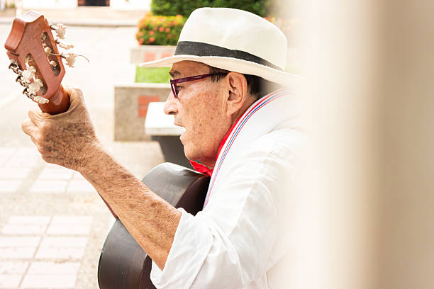 istock A colombian man singing with an acoustic guitar 2206368899