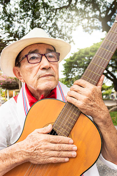 istock A latino man holding a guitar 2206368947