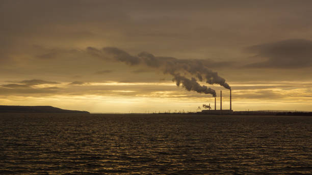 istock factories in open space field sea 2206370146