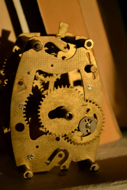 istock Antique clock mechanism with intricate gears showcased in a dimly lit workshop setting 2206371174