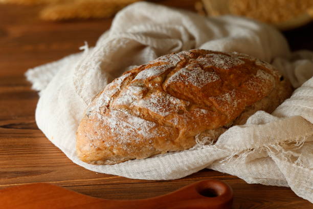 istock A Loaf of Bread on Wooden Table Close-up 2206372091