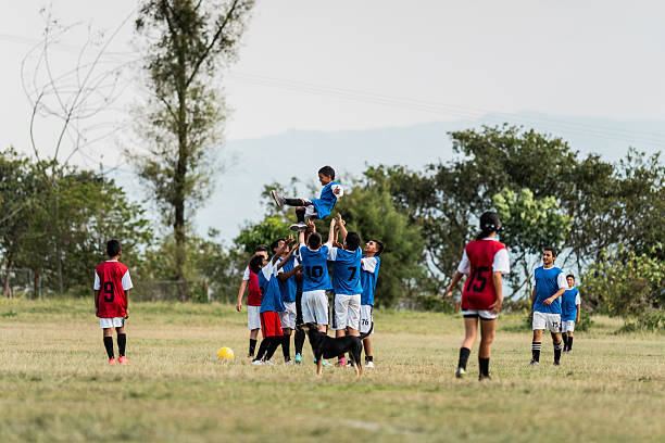 istock Soccer team celebrating on a soccer field 2206372709