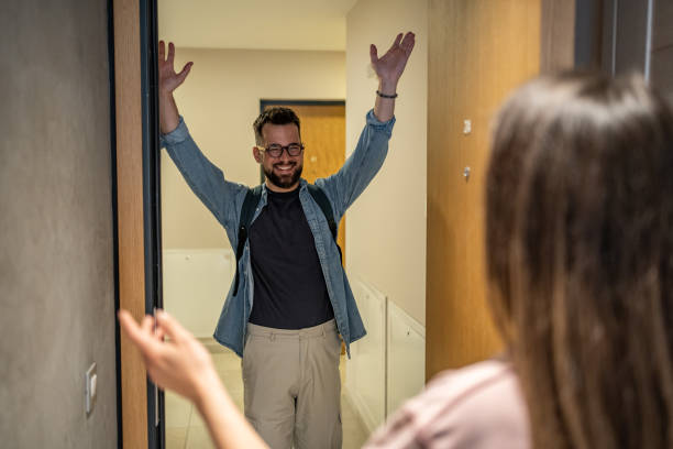 istock Happy man entering home and greeting partner with open arms 2206374311