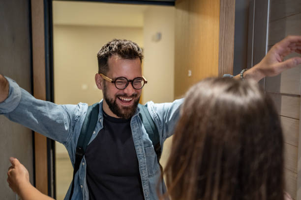 istock Happy man returning home and embracing his partner 2206374318