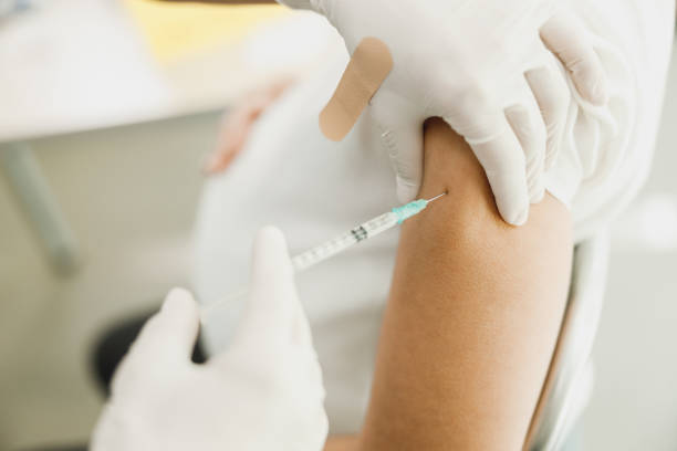 Close-up of a pregnant woman receiving a vaccine due to coronavirus pandemic.