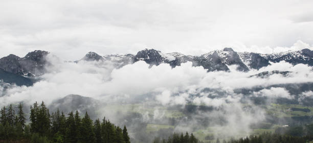 Austrian Mountain Ridge Alpine Peaks Summits View Across Trees Cloudy Low Mist Valley Below Panoramic Photograph