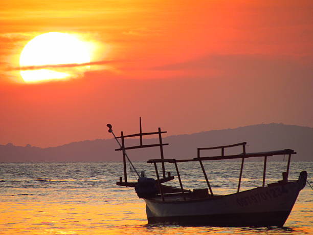 istock Fishing boat and sunset at sea. 2206380301