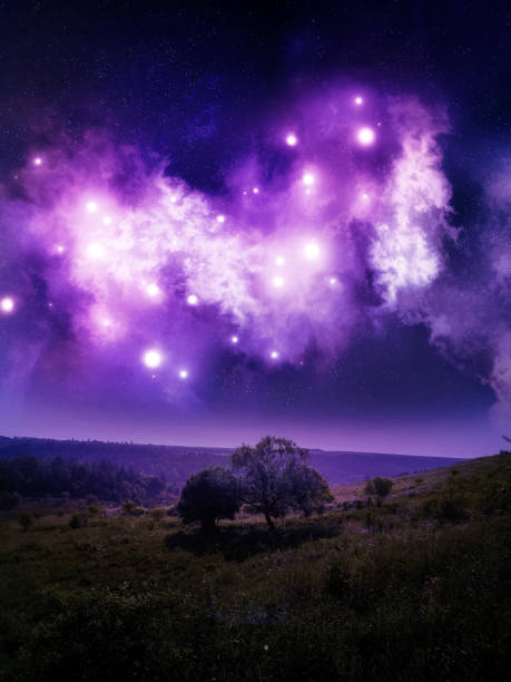Space nebula over hills with trees. Dreamy night landscape with a cluster of stars and cosmic dust. Beauty of the universe.